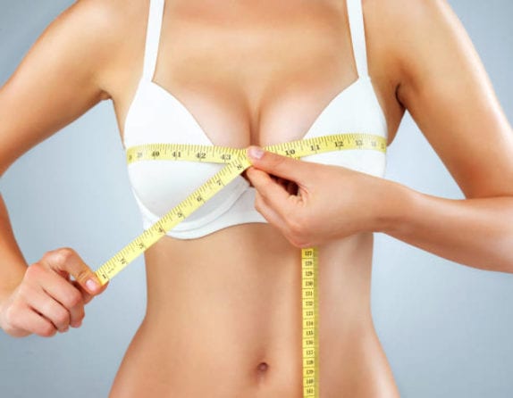 a patient measuring her bust size