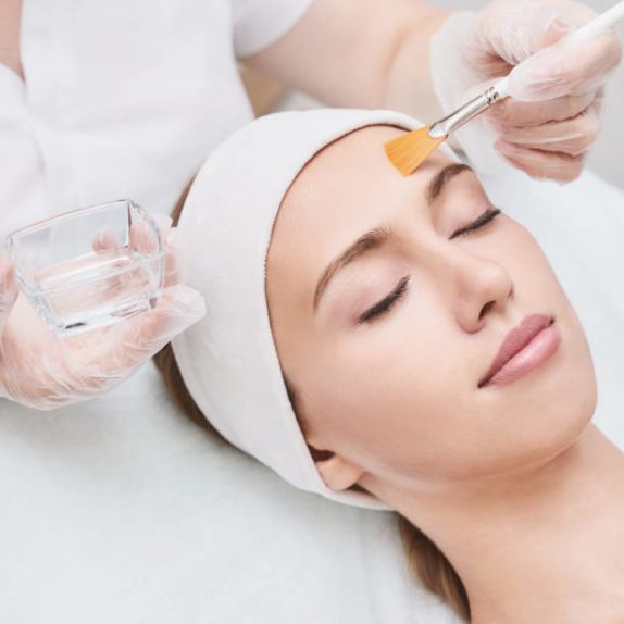 a young patient undergoing a tca chemical peel procedure with a plastic surgeon